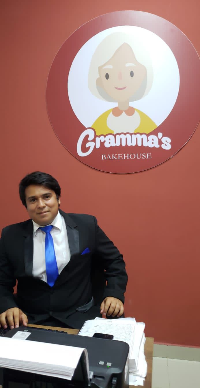 Carlos at the Gramma's Bakehouse administrative desk